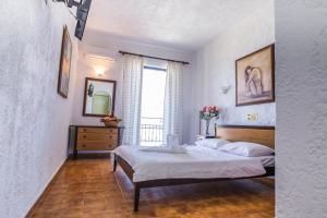 A bed or beds in a room at Creta Aquamarine Hotel