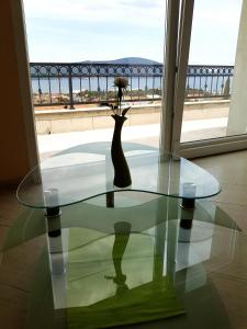 uma mesa de vidro com um vaso em cima em Apartman Milovic em Tivat