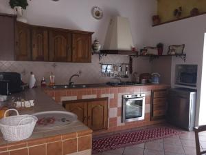 a kitchen with a sink and a stove top oven at Casale Del Borgo in Hermada