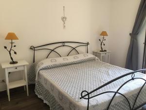 a bedroom with a bed and two tables and two lamps at Casale Del Borgo in Hermada