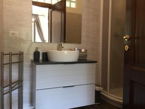 a bathroom with a white sink and a mirror at Casale Del Borgo in Hermada