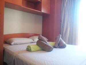 two stuffed animals are sitting on a bed at Holiday Home Turalija in Vodice