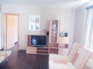 a living room with a flat screen tv and a couch at Holiday Home Turalija in Vodice