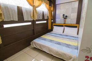 Postel nebo postele na pokoji v ubytování Luyi Ludao B&B