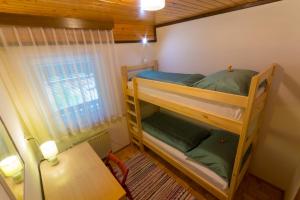 a bedroom with two bunk beds and a table at Apartment Stefelin in Bled
