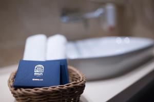 a basket of toiletries on a counter with a sink at Hotel Riva by Aycon in Petrovac na Moru