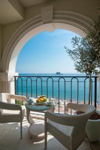a balcony with a table and chairs and a view of the beach at Hotel Riva by Aycon in Petrovac na Moru