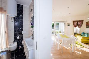 a kitchen and living room with a table and a tub at Boutique Villa Nirvana in Pag +146 photos