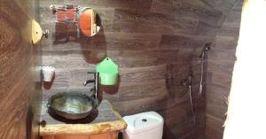 a bathroom with a sink and a toilet at La Colline Aux Cabanes in Espaly-Saint-Marcel
