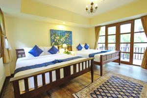 Postelja oz. postelje v sobi nastanitve Shewe Wana Suite Resort