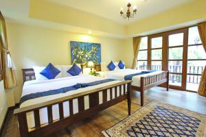 Postel nebo postele na pokoji v ubytování Shewe Wana Suite Resort