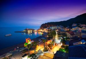 a view of a city at night at Hotel Riva by Aycon in Petrovac na Moru