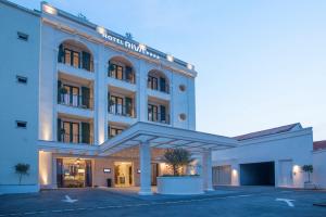 a hotel with a large building with a parking lot at Hotel Riva by Aycon in Petrovac na Moru