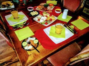 a wooden table topped with plates of food and drinks at Ferienwohnungen-Willrich-Ferienwohnung-1 in Blankenheim