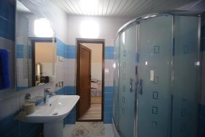 a bathroom with a shower, sink, and toilet at Hotel Balcony in Kutaisi