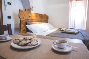 Postel nebo postele na pokoji v ubytování Trulli-eu Guesthouse Alberobello