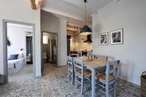 a kitchen and dining room with a table and chairs at Alia Luxury Apartment in Gaios