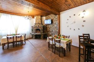 a dining room with a table and a clock on the wall at House of Time in Ognyanovo