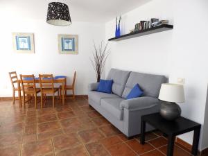 a living room with a couch and a table at Apartamentos Medano - Atico Playa in El Médano