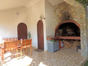 a room with a stone fireplace and a wooden bench at Apartments Marinovic in Brzac