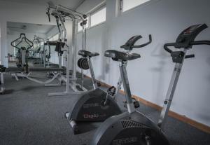 a gym with several exercise bikes in a room at Frixos Hotel in Malia