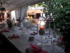 a table set up for a party with candles and chairs at Le Querce Hotel in Salsomaggiore Terme +150 photos