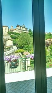 a view from a window of a balcony with flowers at B & B Abbadia in Monesiglio