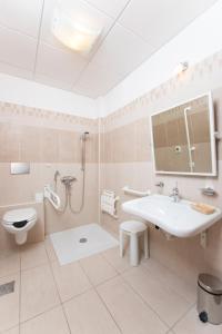 a bathroom with a sink and a shower and a toilet at Hotel Letizià in Borello