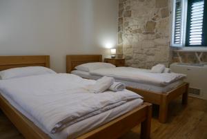 Posteľ alebo postele v izbe v ubytovaní Guest house Jere Old Town