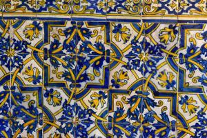 a blue and white tile floor with blue and yellow flowers at Noble House Essence Évora - by Unlock Hotels in Évora