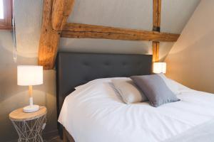 1 dormitorio con 1 cama blanca y 2 almohadas en HISSLA ALSACE CHIC& COSY BARR Wine Route, en Barr