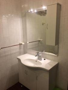 a white bathroom with a sink and a mirror at Apartments Toni-Malinska in Malinska +37 photos