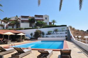 a villa with a swimming pool in positano at Castri Village Hotel in Palekastron