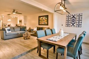 a dining room and living room with a table and chairs at Casa Azul in East End