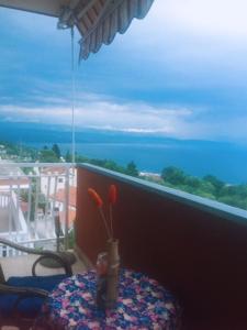 a table with a vase on a table with a view of the ocean at Studio Apartment Blue Dream in Ičići