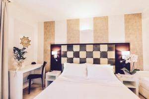 Voodi või voodid majutusasutuse JR Resort Logos Forte dei Marmi toas