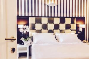 Voodi või voodid majutusasutuse JR Resort Logos Forte dei Marmi toas