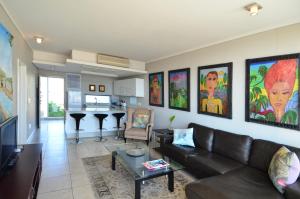 a living room with a couch and a table at 214 Harbour Bridge in Cape Town