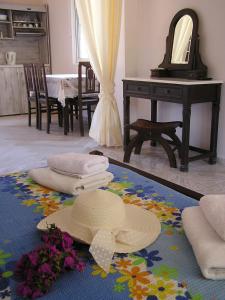 a hat and flowers on the floor of a room at Eolos Apartments with Private Parking in Agios Nikitas