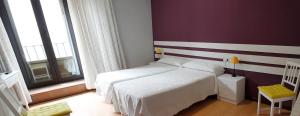 Postel nebo postele na pokoji v ubytování Hostal San Martin
