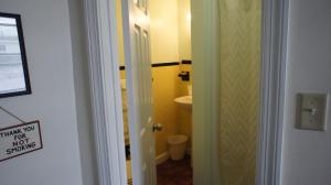 a bathroom with a toilet and athank you for your shower sign at Atlantic Sands in Hampton