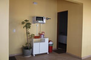 a room with a white cabinet and a tv on the wall at Guaiamu Suítes Ilhabela in Ilhabela +92 photos