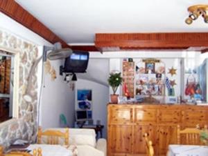 
a kitchen with a table and a microwave at Panorama Hotel in Kalymnos
