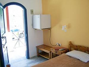 a bedroom with a bed and a desk at Panorama Hotel in Kalymnos
