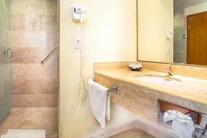a bathroom with a sink and a shower at Hotel Los Itzaes by 5th av in Playa del Carmen +63 photos