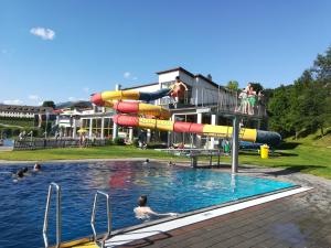 a group of people in a pool with a water slide at Ferienhaus Tüchler in Tamsweg