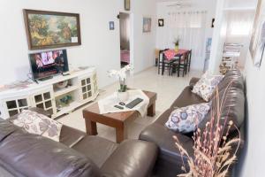 a living room with a couch and a table at Dead Sea Yehuda Apartments in Arad