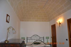 Postel nebo postele na pokoji v ubytování Masseria Fragnale