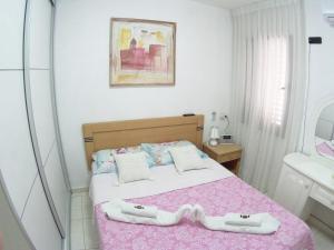 a bedroom with a bed with two towels on it at Dead Sea Yehuda Apartments in Arad