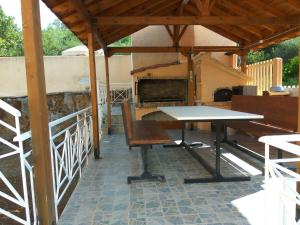 a table and a bench on a patio at Bella Vista in Yiáltra